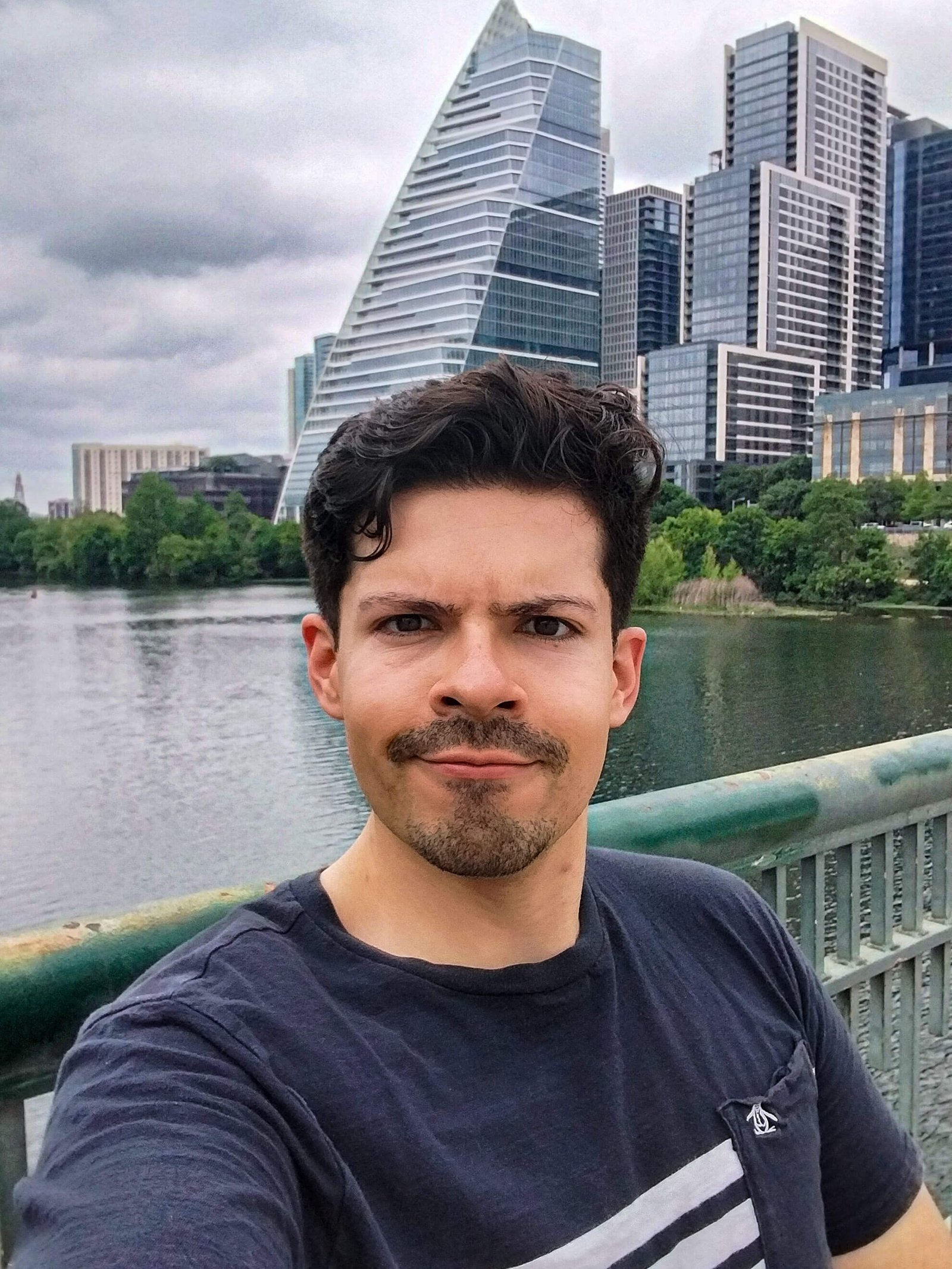 A photo of Gustavo with the Austin skyline in the background.