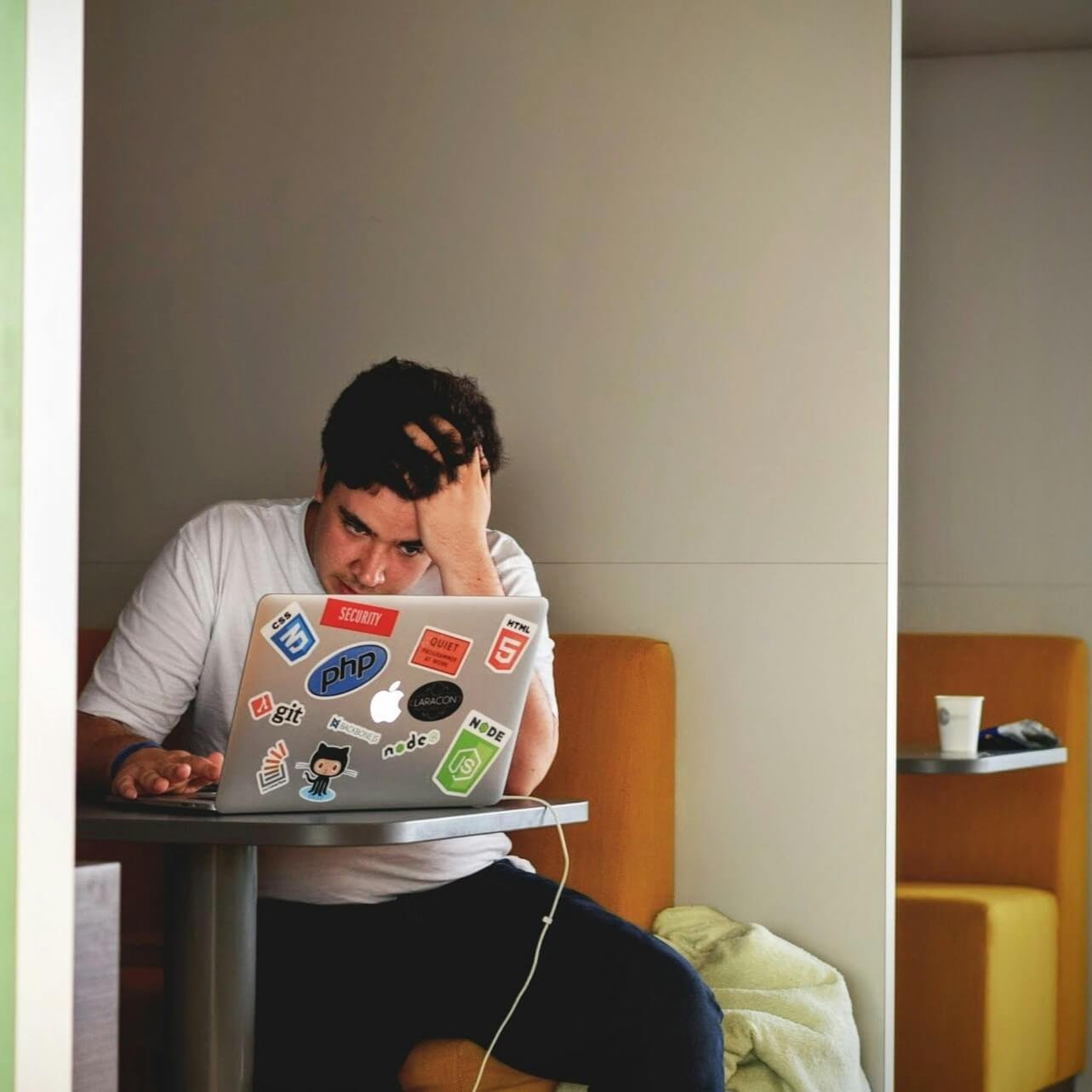 Man full focus using laptop at a coffee shop